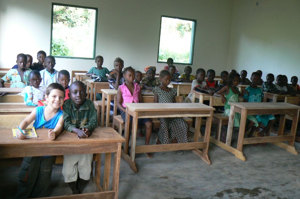 Children sitting at wooden desks in the classroom